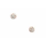 18 carat pink gold cluster diamond ear studs. Each stud is set with a center diamond of ca. 0.10 ct.