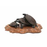 A Japanese bronze okimono in the manner of Rokusai. Three clambering tortoises. Signed on belly.