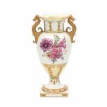 A porcelain baluster vase, decorated with flower bouquets and highlighted in gold. With gilt griffin