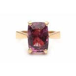 A 14 carat yellow gold ring, set with a mixed cut, natural Ceylon purplish-pink spinel of ca. 8.55