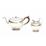 A Dutch Sterling silver teapot and milkjug. Maker's mark Jacques Vos & Co., Haarlem. Year letter