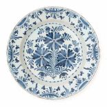 A Delft blue and white charger, decorated with a floral pattern. 18th century.Diameter 35 cm.- - -