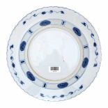 A Chinese blue and white plate, decorated with an elegant lady and a playing boy in a garden,