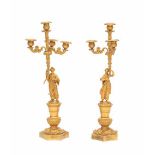 A pair of gilt-bronze four-light candelabra. 19th century. With a male and female figure in