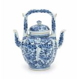 A Chinese blue and white double-spouted ewer, decorated with panels of flowers. Kangxi period (