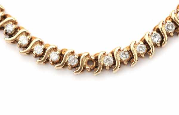 A yellow gold tennis bracelet with S-shaped links. Set with brilliant cut diamonds, total ca. 1.95 - Image 2 of 2