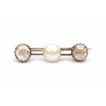 14 carat gold bar brooch set with a cultured bouton pearl and two rose cut diamonds with a