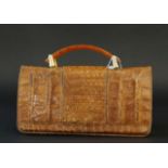 Croco handbag with celluloid handle, wear and tear, dim. 17 x 27 cm. 27.00 % buyer's premium on the