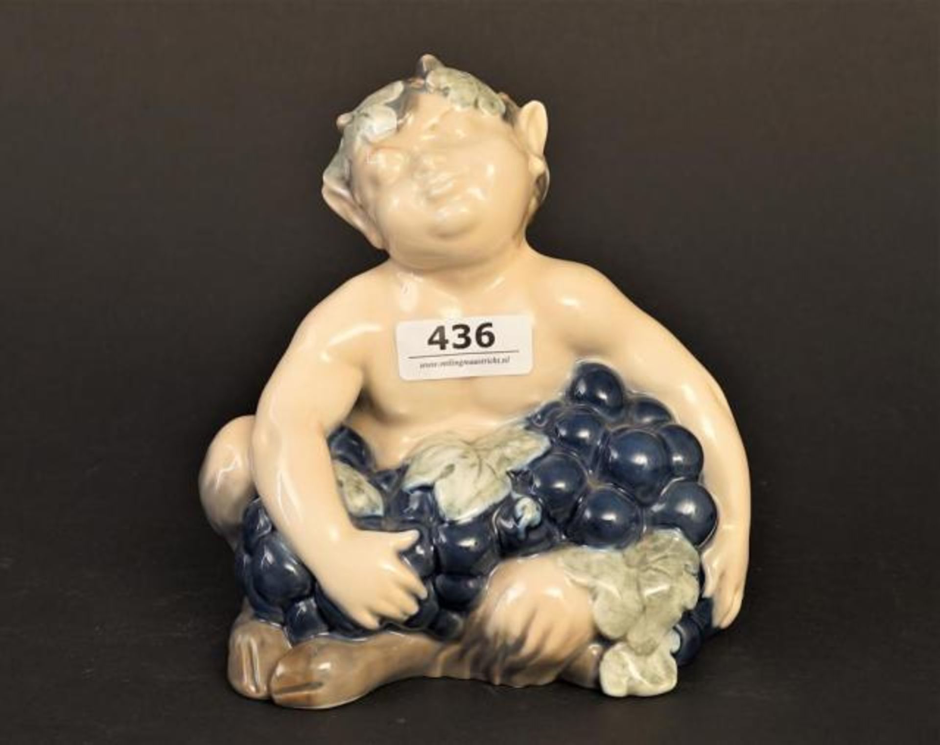 Porcelain Royal Copenhagen figure, Faun with grapes, h. 12 cm.