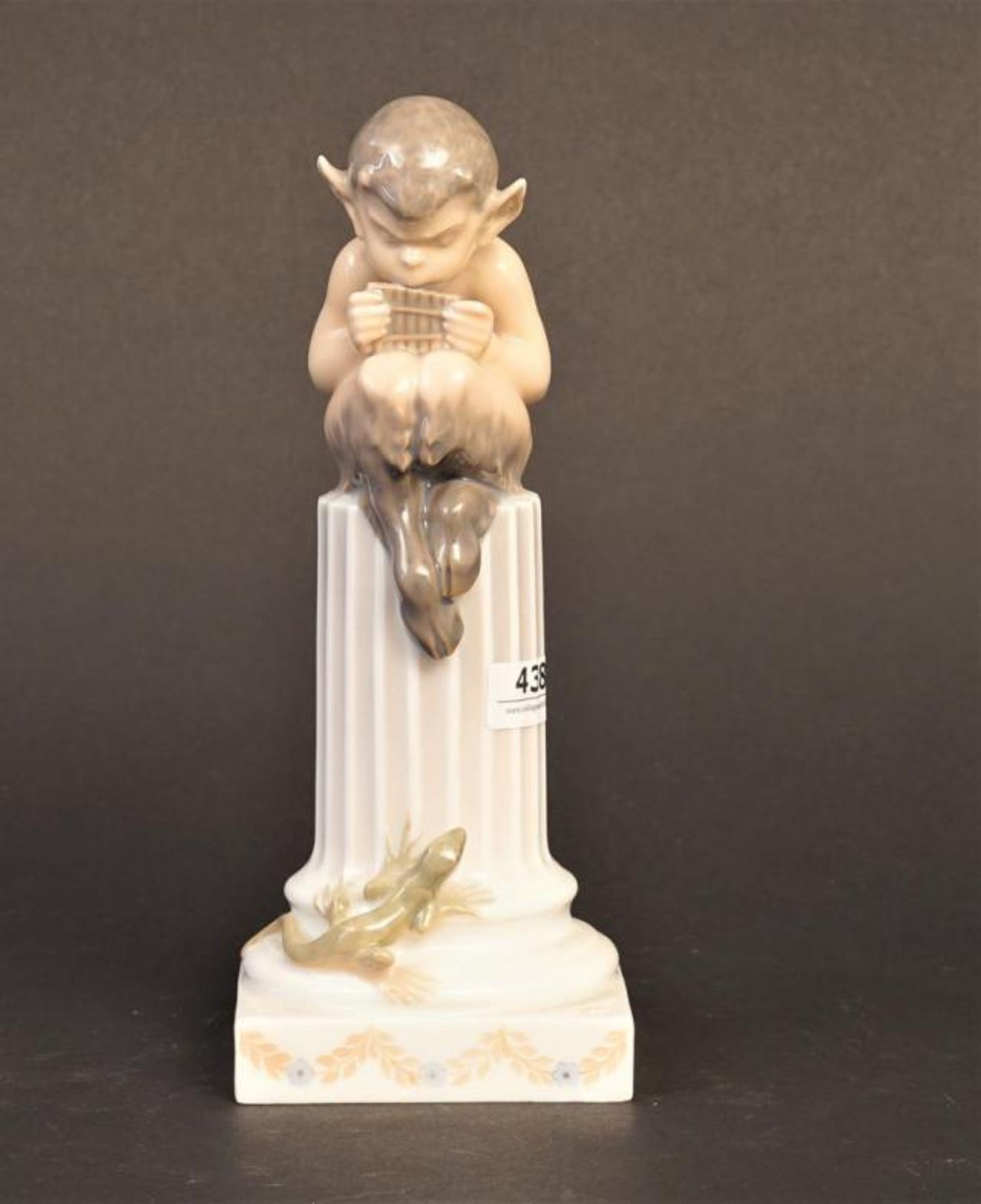 Porcelain Royal Copenhagen figure, Faun on column, h. 21 cm.