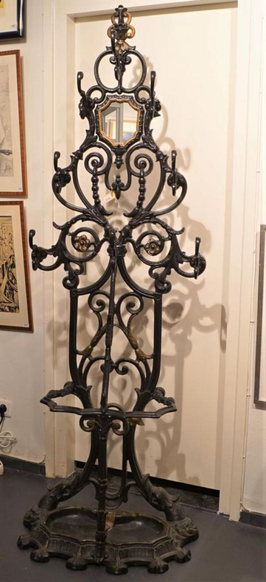Cast-iron coatrack with built-in umbrella stand and mirror, 19th century, dim. 195 x 68 cm.