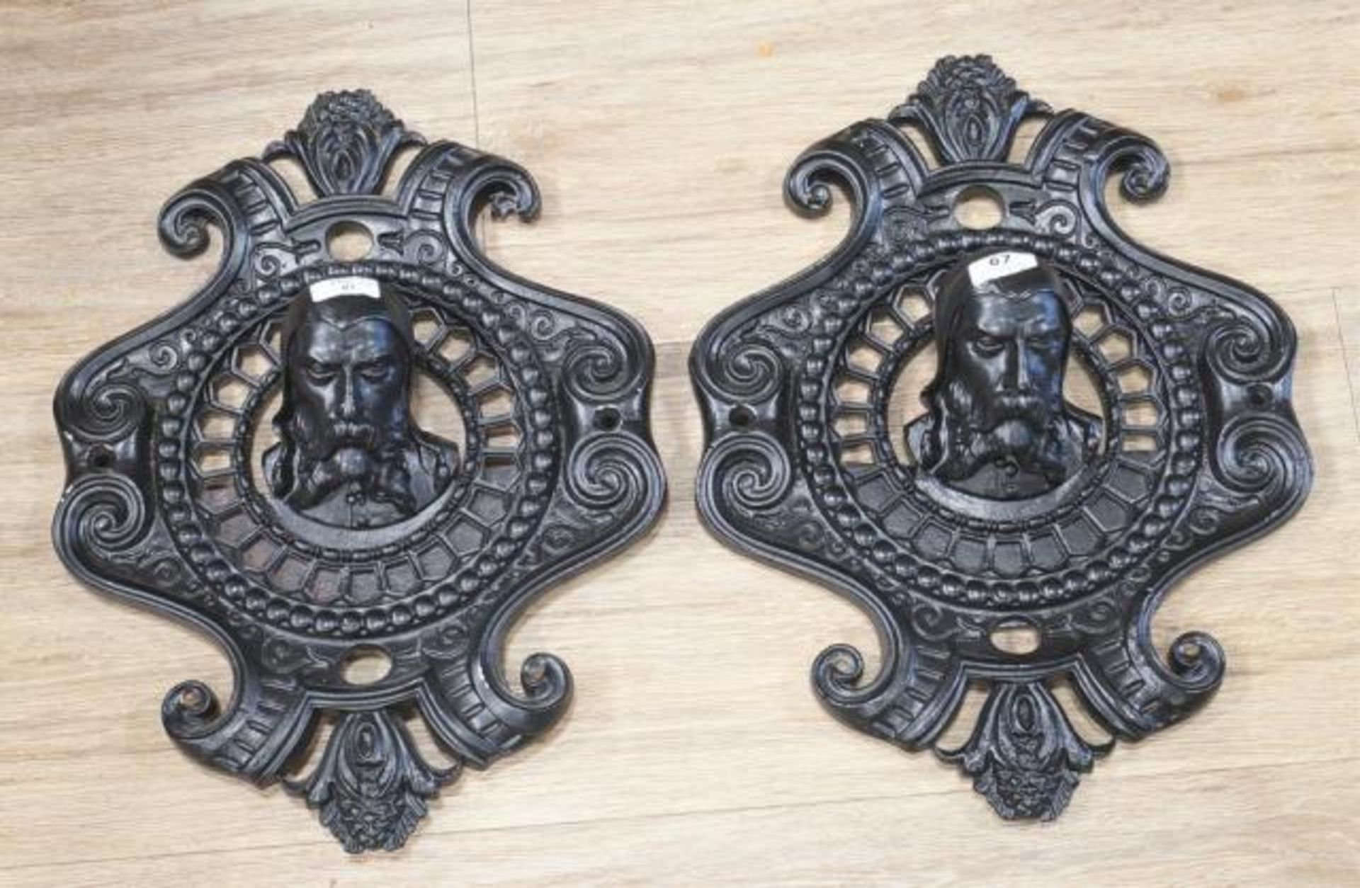 Pair of iron ornaments with black paint, Heads, 19th/20th century, l. 39 cm (2x)