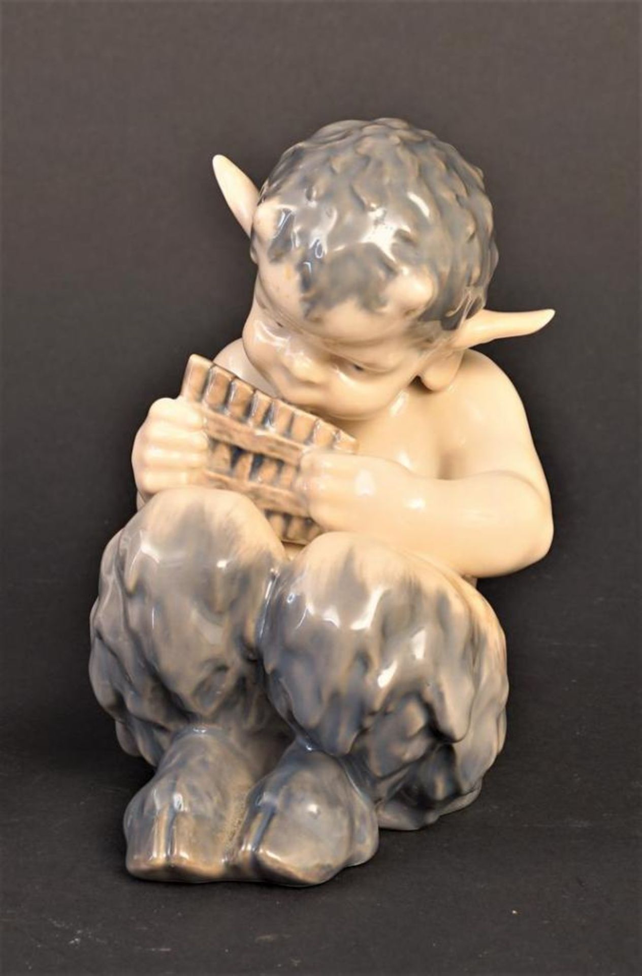 Porcelain Royal Copenhagen figure, Faun with pan flute, h. 14 cm.