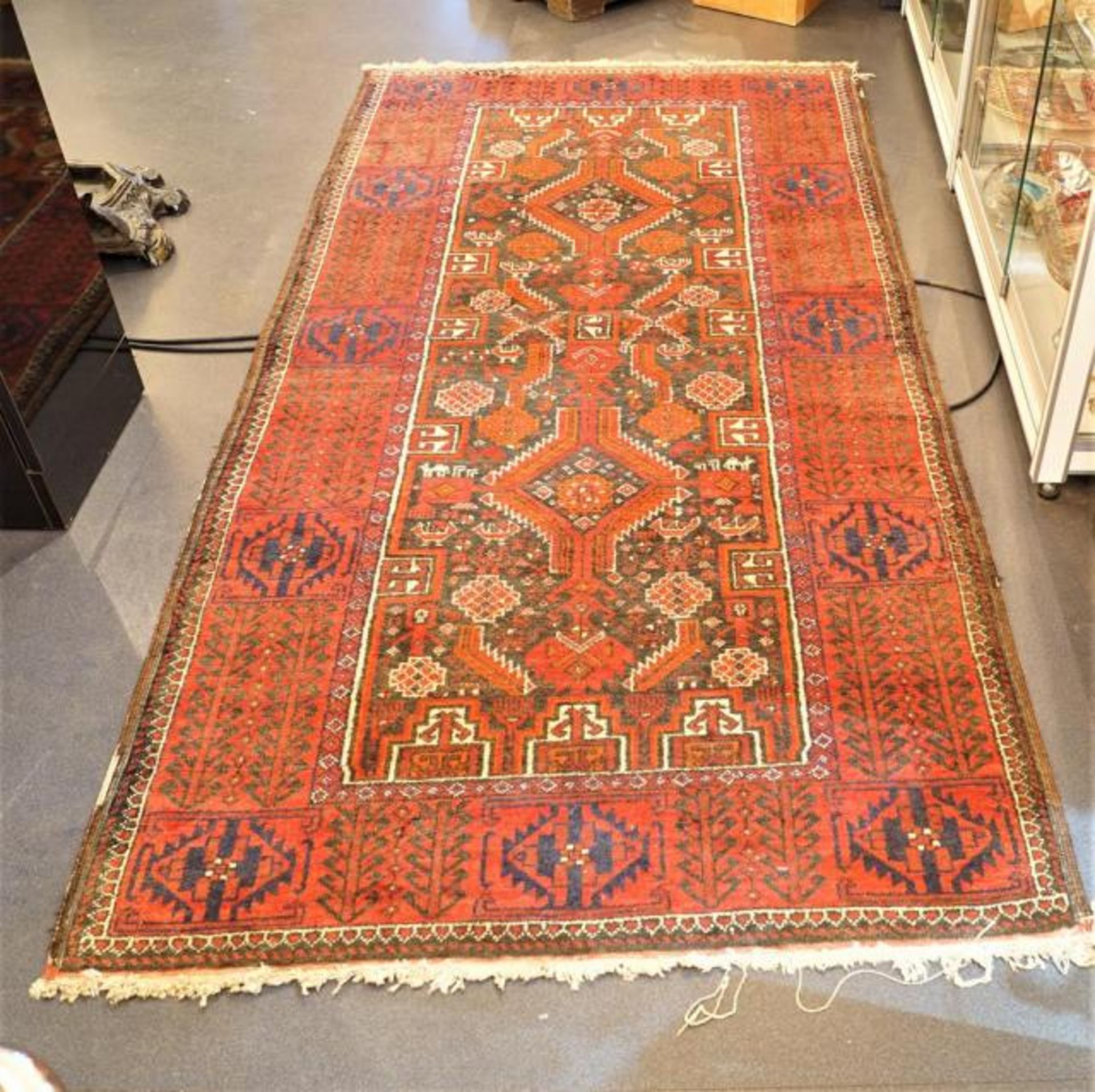 Persian carpet, rim with wear and tear, dim. 204 x 102 cm.