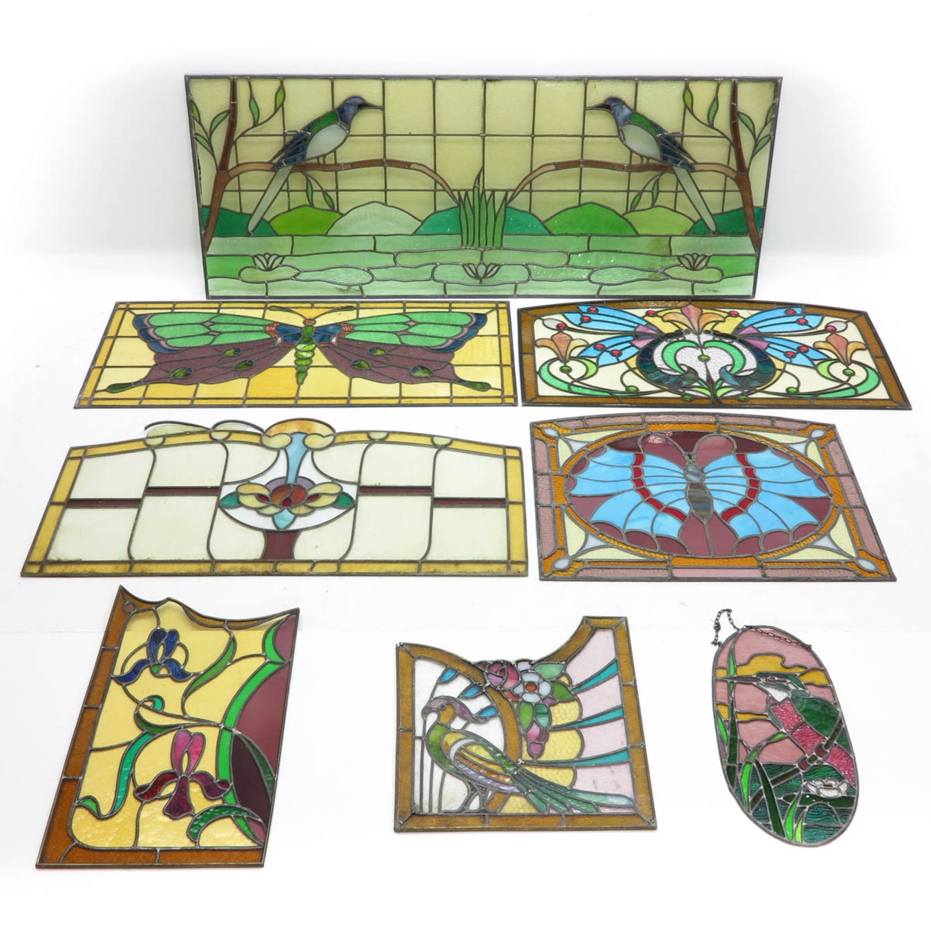 A Collection of Eight Art Nouveau Stained Glass Panels