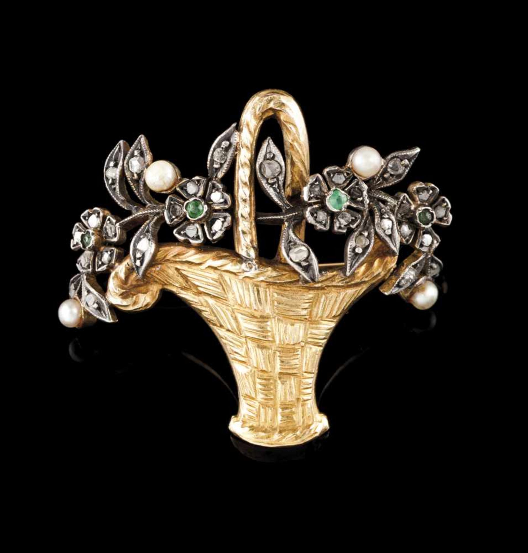 A broochGold and silver set with small pearls, emeralds and rose cut diamondsDesigned as a