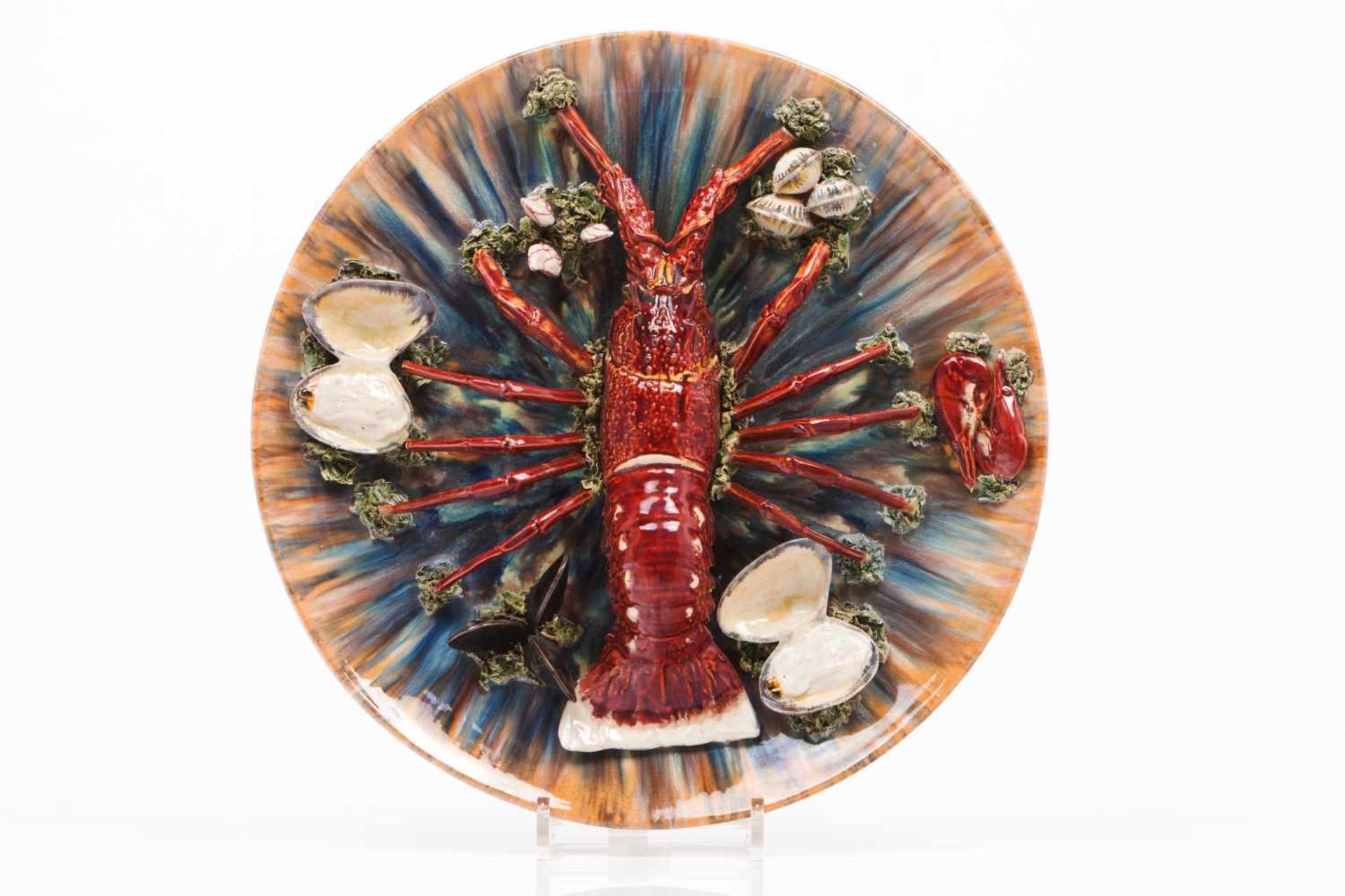 A platePortuguese faienceCaldas da RainhaPolychrome decoration in relief with lobster, bivalves