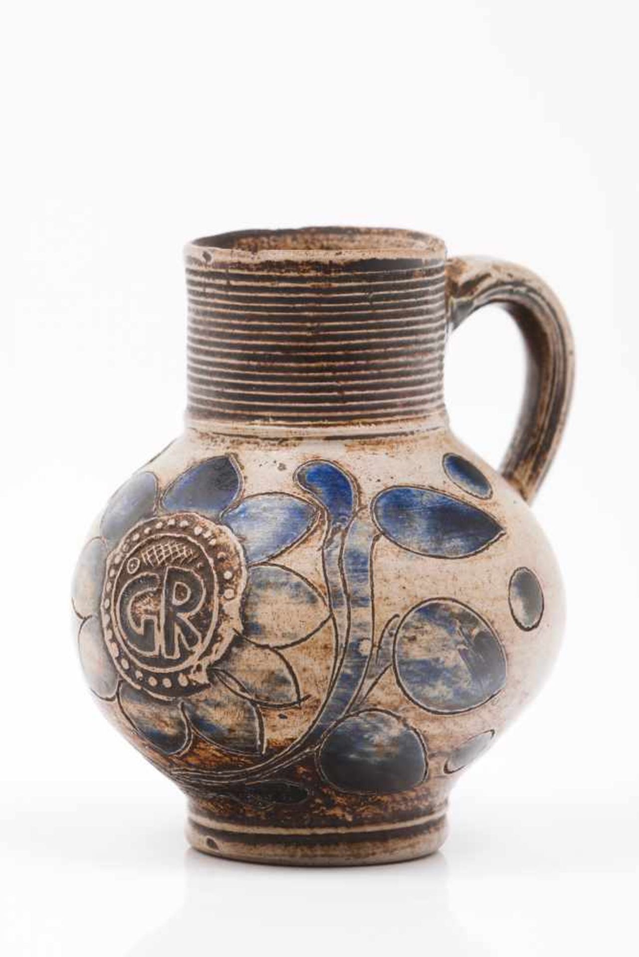 A small jugGlazed stonewareBlue decoration with stylized floral motifsEngraved "G.R."