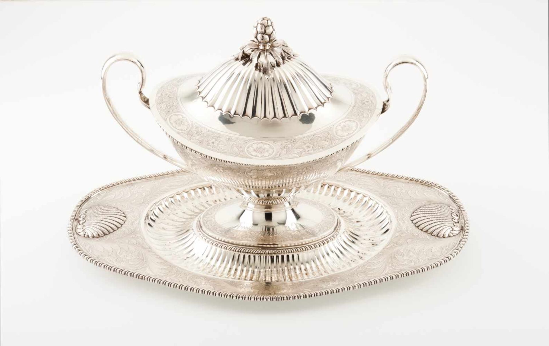 A large tureen and platterPortuguese chiselled silver with foliage scroll motifs. The platter with 2