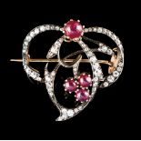 A broochBicolour gold, set with 4 cabochon rubies and various vintage round brilliant cut