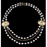 A necklace18kt gold wire, grey baroque cultured pearls; 18kt gold clasp, medallions with feminine