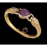 A bangle, LUIZ FERREIRA19kt gold chiselled as two snakes and set with one carved ruby and 12