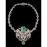 A necklace/broochSilver and 800/000 gold with a central segment, set with 2 emerald roots; one (