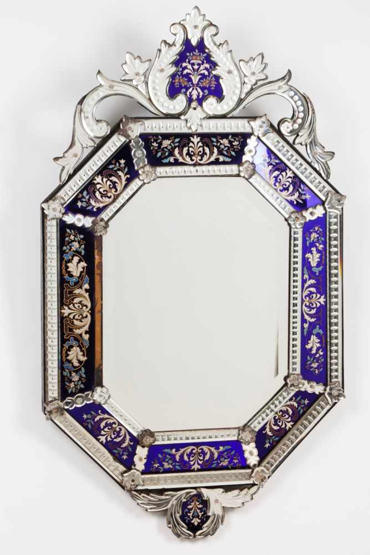 A Venetian mirrorOctagonal, with engraved decoration of floral motifs Scalloped crest and apron