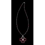 A chain with a pendant750/000 gold, set with small round brilliant cut diamonds and faceted ruby