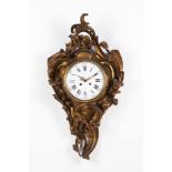 A Louis XV style wall clockGilt bronzeDecorated in reliefStrikes at hours and halvesEnamel dial with