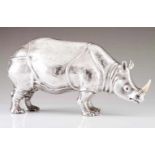 A large Manuel Alcino rhinocerosRepoussé and chiselled Portuguese silver sculpture with applied