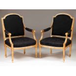 A pair of Louis XV style armchairsCarved and gilt woodBack, seat and arms covered in black
