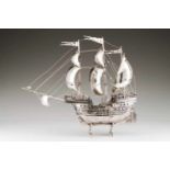 A large CaravelWith unfurled sails, Portuguese silver. Minutely detailed human figures, canons,