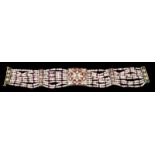 An Indian traditional braceletNine rows of seed pearls and ruby beadsSpacers, clasp and central