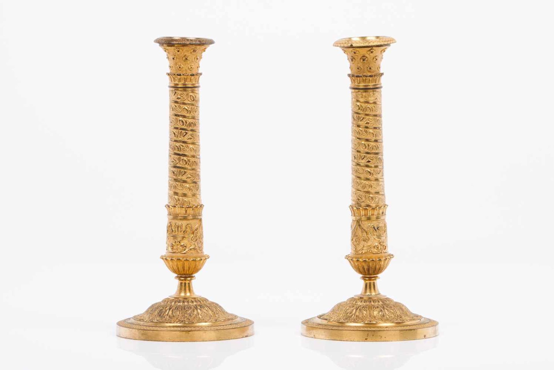 A pair of French Restoration period candleholdersPatinated and gilt bronzeFluted and raised