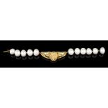 A braceletBaroque cultured pearls, 18kt gold centre decorated in relief with feminine profile and