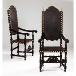 A pair of armchairsIn darkened woodFigure and floral engraved leather backs and seats fixed by brass