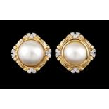 A pair of earrings750/000 gold, set with freshwater half pearls and 12 round brilliant cut