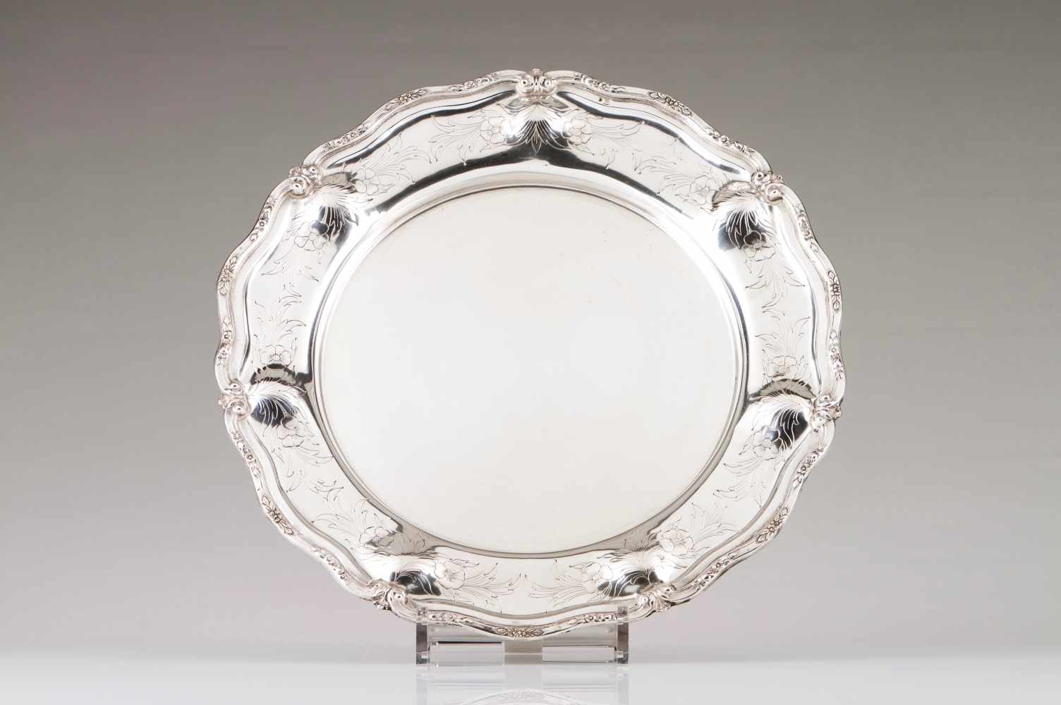 A salverPortuguese silver. Plain centre with foliage and flower scroll, raised and chiselled