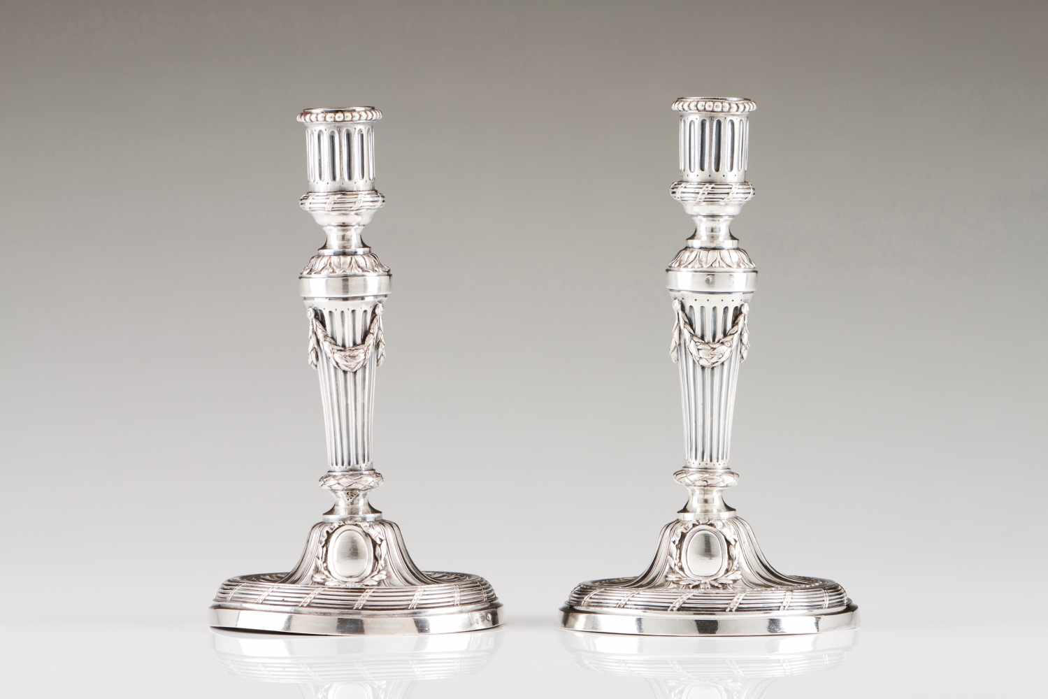 A pair of candlestands18th c. French silverLouis XVI fluted and flower garland decorationParis assay