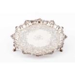 A salverEnglish silverCentral monogram with chiselled band and foliage scroll motifs on the