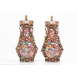A pair of vases with coversChinses export porcelainDecorated in relief and Famille Rose enamels
