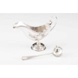 A Belle-Époque sauce boatPortuguese silver decorated in relief in the rocaille manner, ladle with