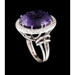 A ringPlatinum and gold. Double ring with crib set amethyst (17x15mm) framed by small round