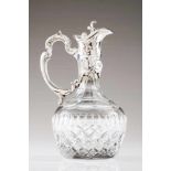 A liquor jugCut-crystal; Portuguese silver handle and mount with cover decorated in relief in the