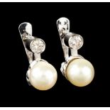 A pair of earringsWhite gold, set with 2 round brilliant cut diamonds weighing (ca.0.40ct) and 2