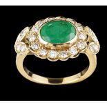 A ring18kt gold set with one oval cut emerald and 22 brilliant cut diamonds (ca. 0,44ct)Brazil,