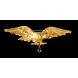 A broochCarved and chiselled gold, depicting an open winged eagle, holding a diamond in its beak and