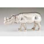 A large Manuel Alcino rhinocerosRepoussé and chiselled Portuguese silver with applied ivory elements