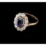 A ringSet in two-toned gold with one oval synthetic sapphire and 12 antique brilliant cut